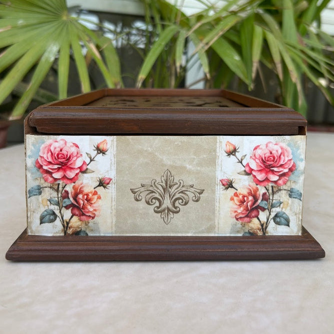 Decorative box with floral design on a neutral background