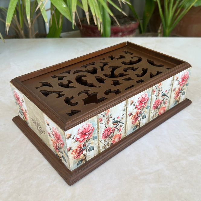 Decorative wooden box with floral design on a light surface