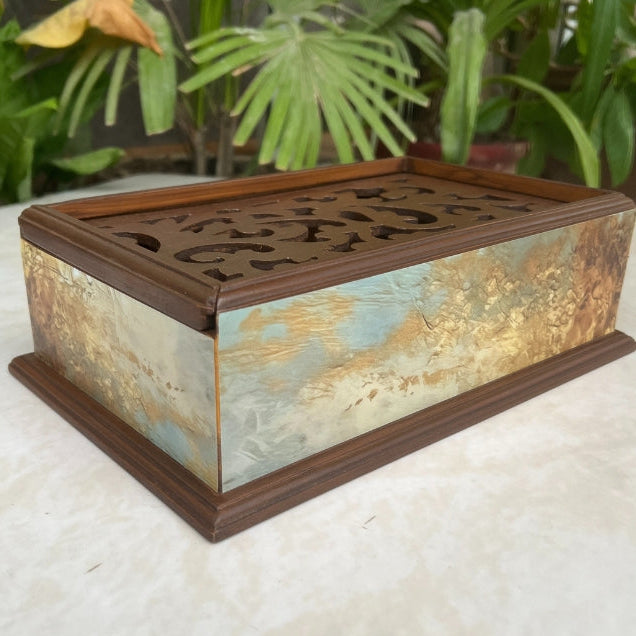Decorative box with intricate design on a white surface