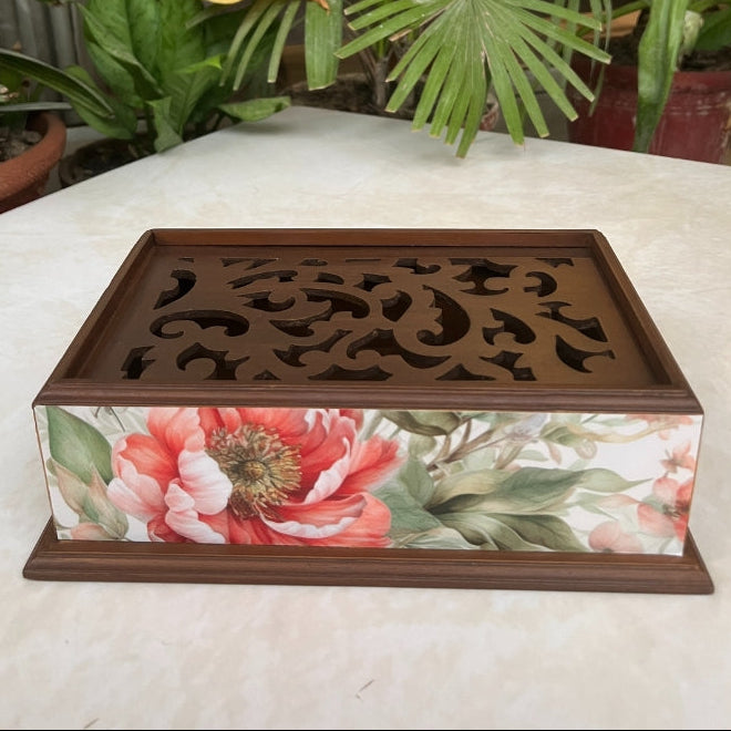 Decorative wooden box with floral design on a table