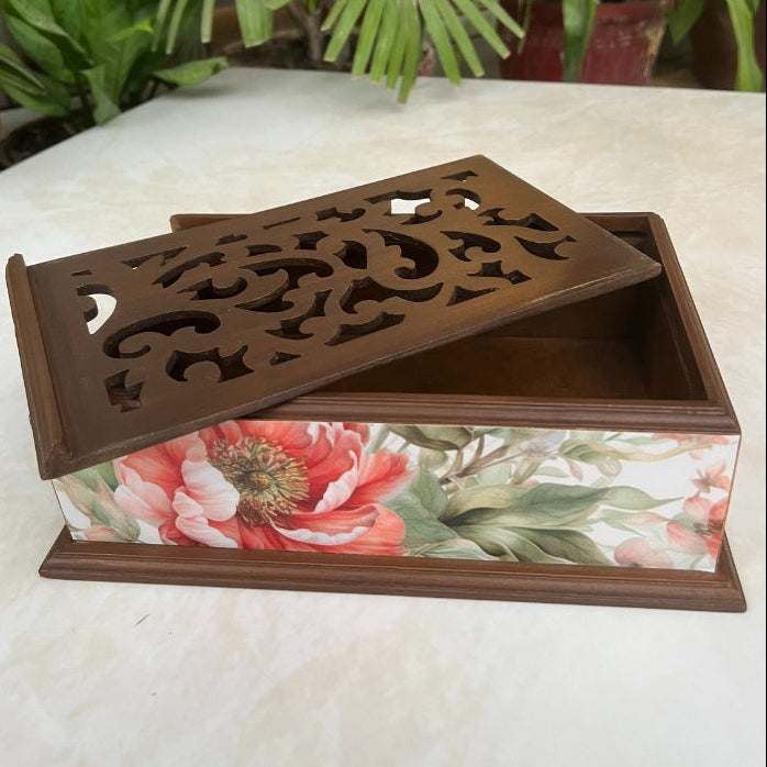 Decorative box with floral design and ornate lid on a white surface