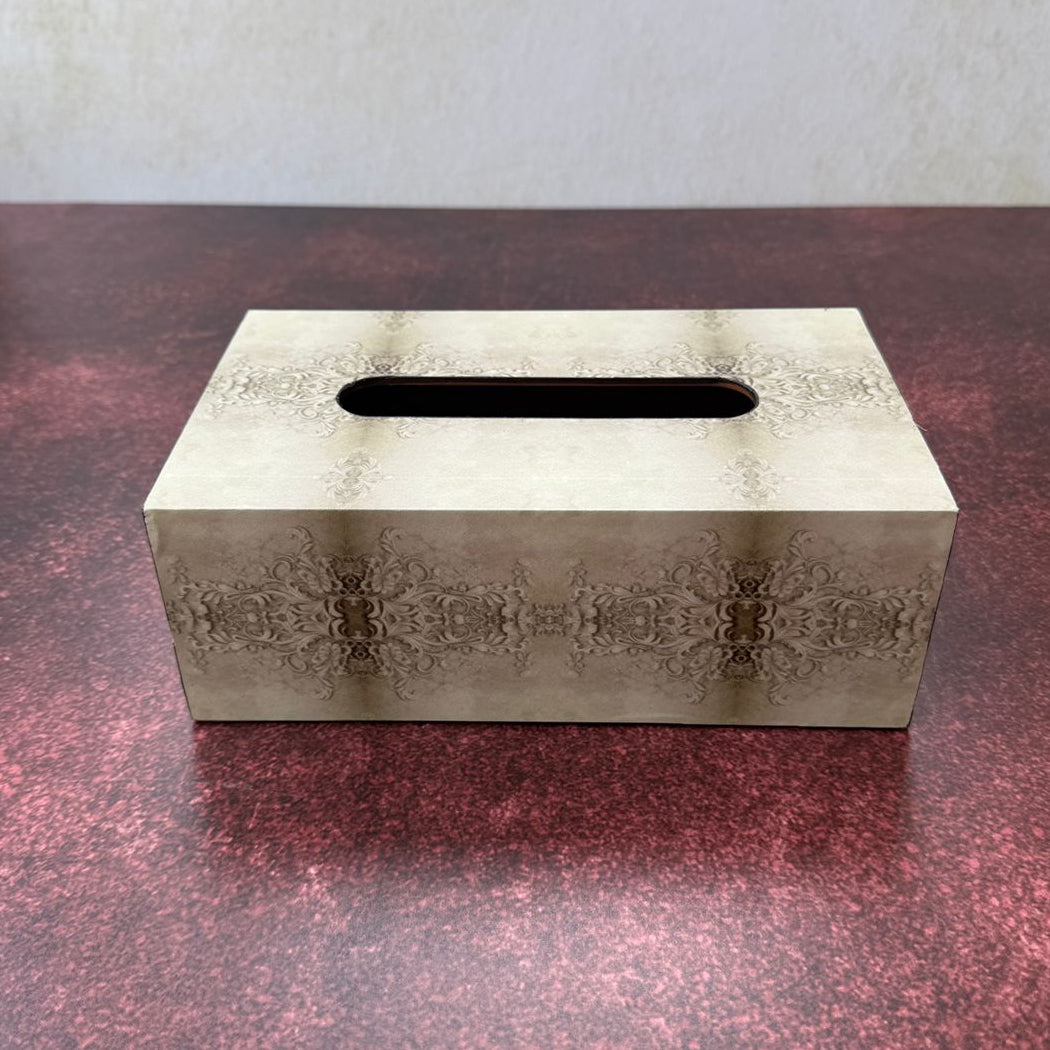 Decorative tissue box cover with intricate patterns on a textured surface
