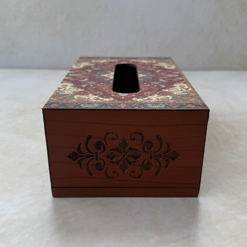 Maroon rectangular tissue box with decorative pattern on a white surface