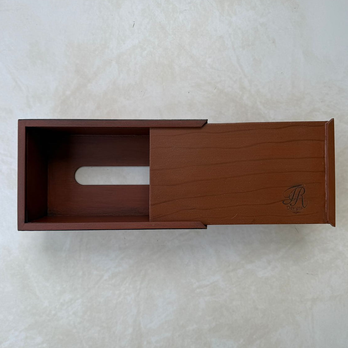 Bottom view of wooden tissue box on a beige textured background