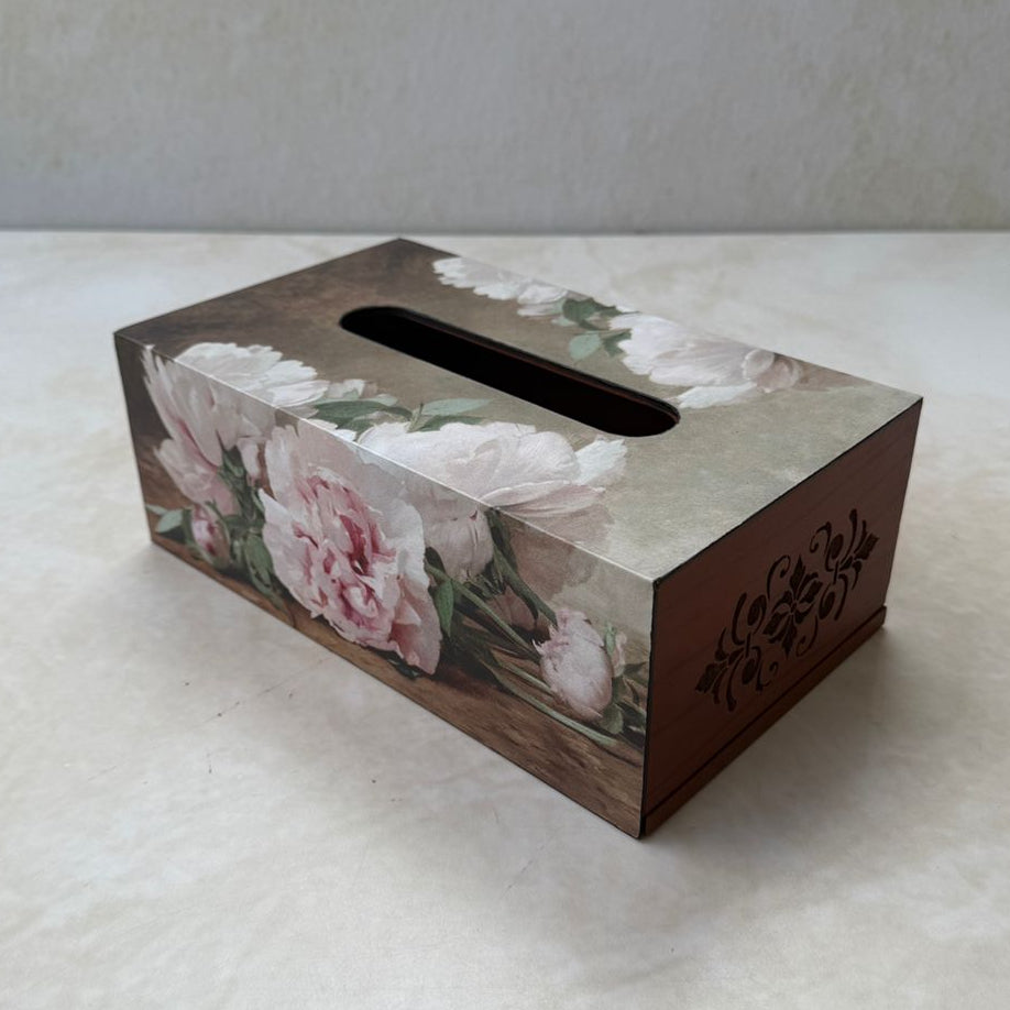 Floral-patterned tissue box on a white surface with a light gray background