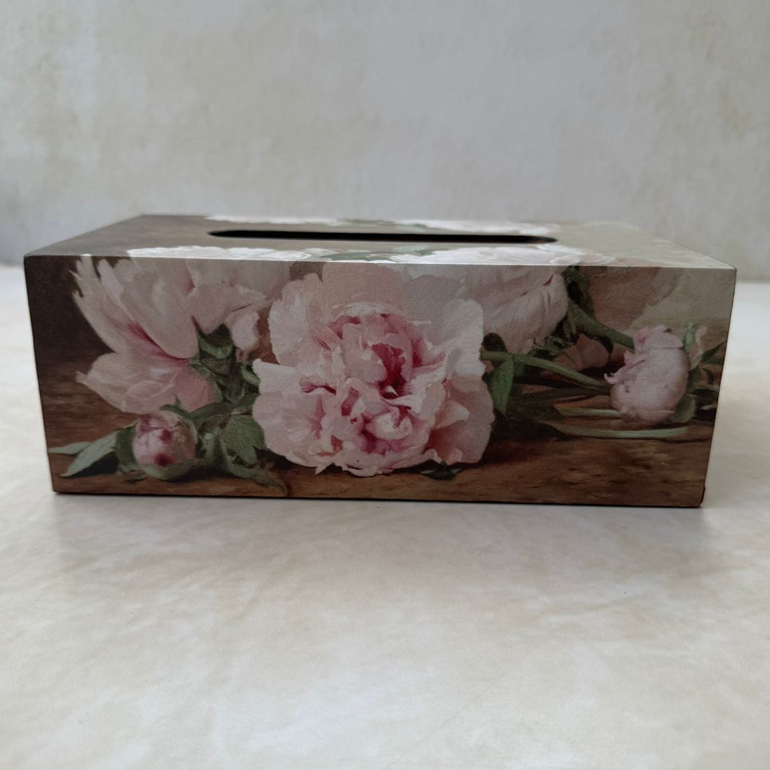 Floral-patterned tissue box on a white surface