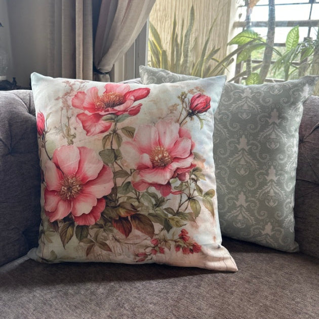 Floral pillow on a couch with a neutral background