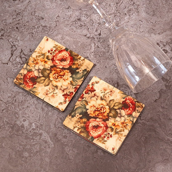 Two floral coasters on a textured surface.