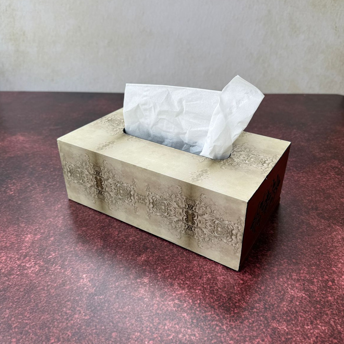 Decorative tissue box with embossed design on a textured surface