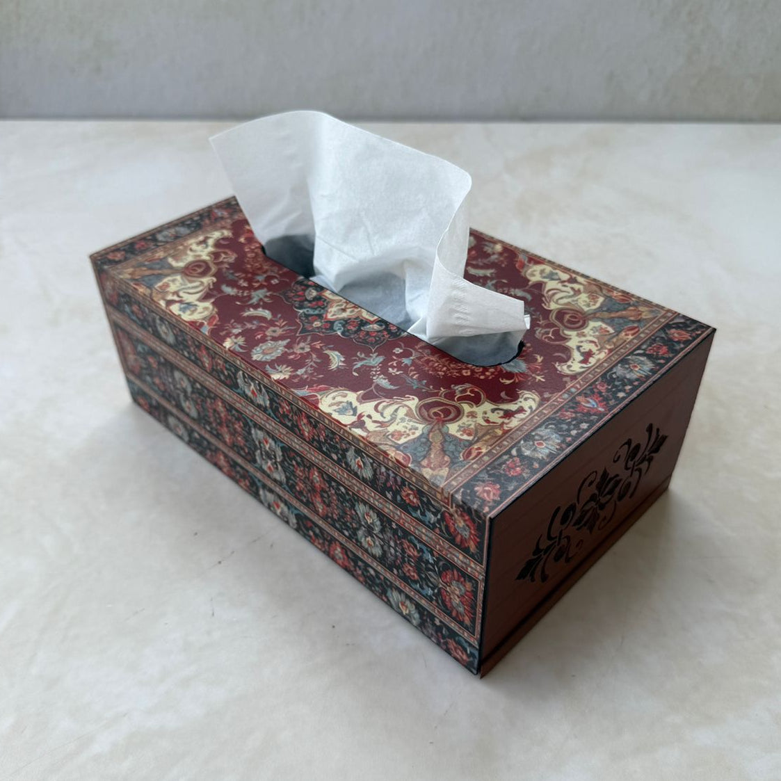 Decorative tissue box with persian patterns on a white surface