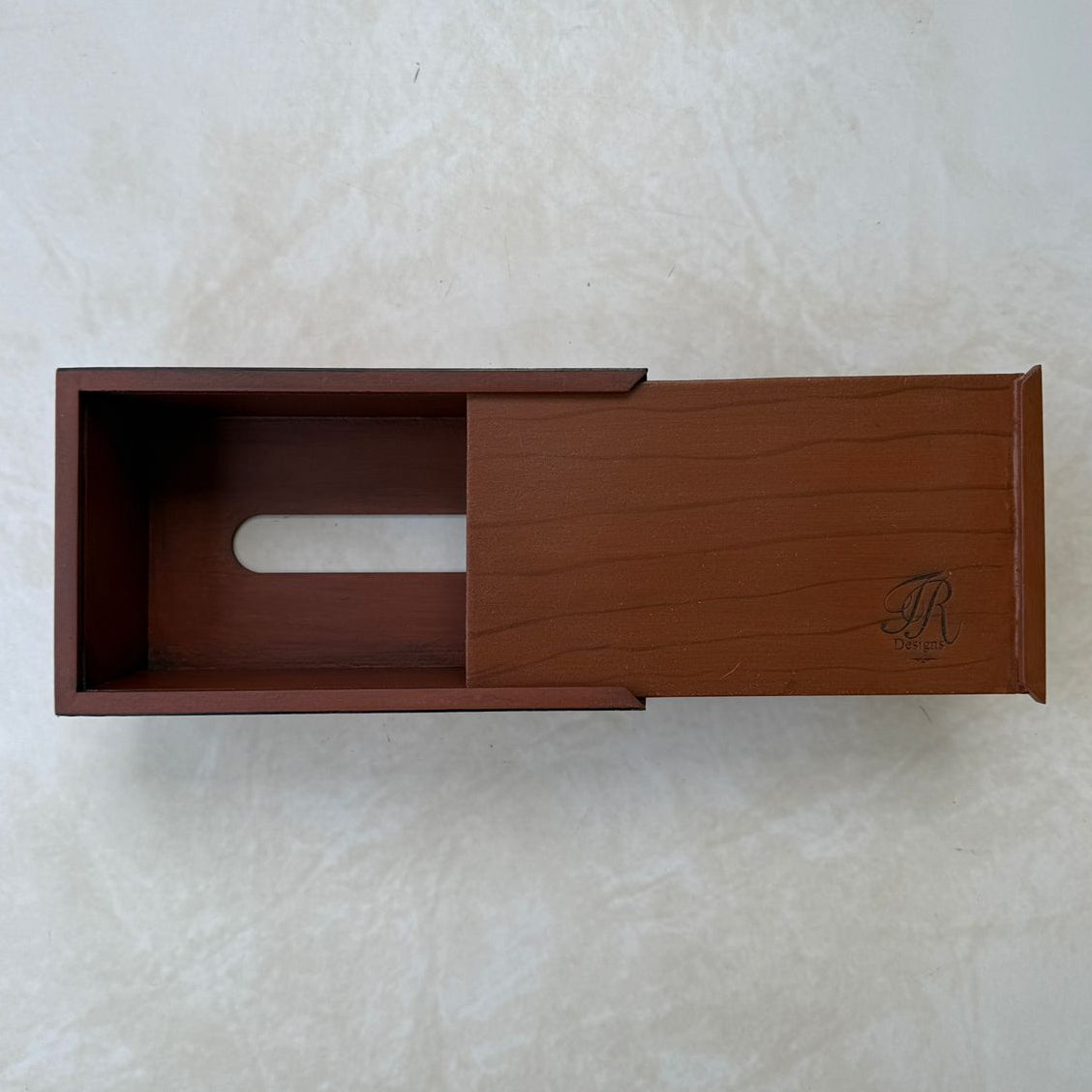 Bottom view of wooden tissue box on a beige textured background
