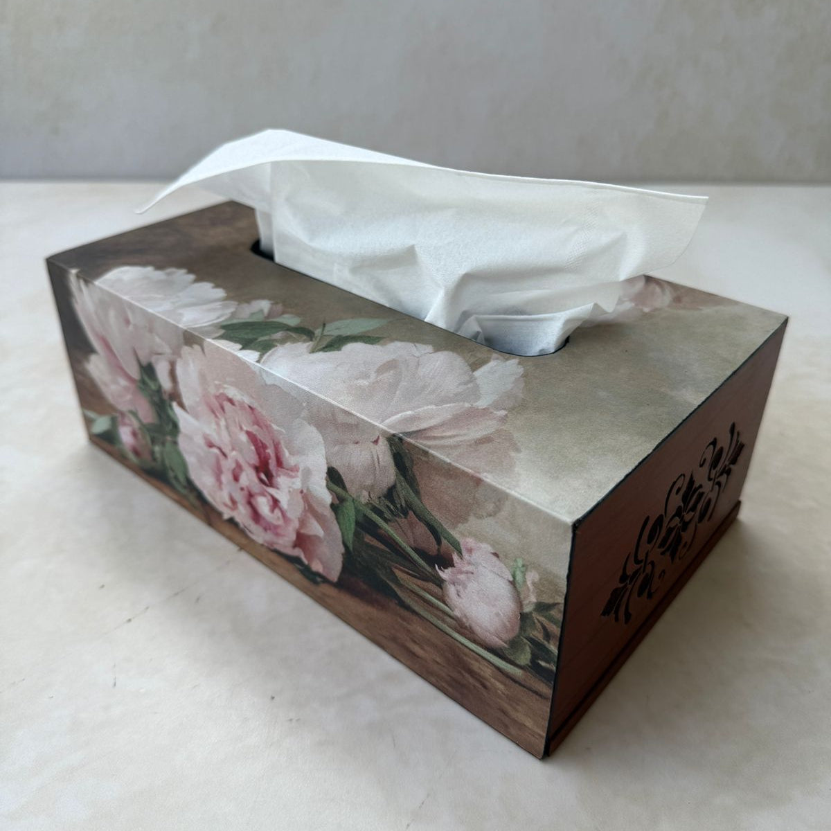 Tissue box with floral design on a white surface