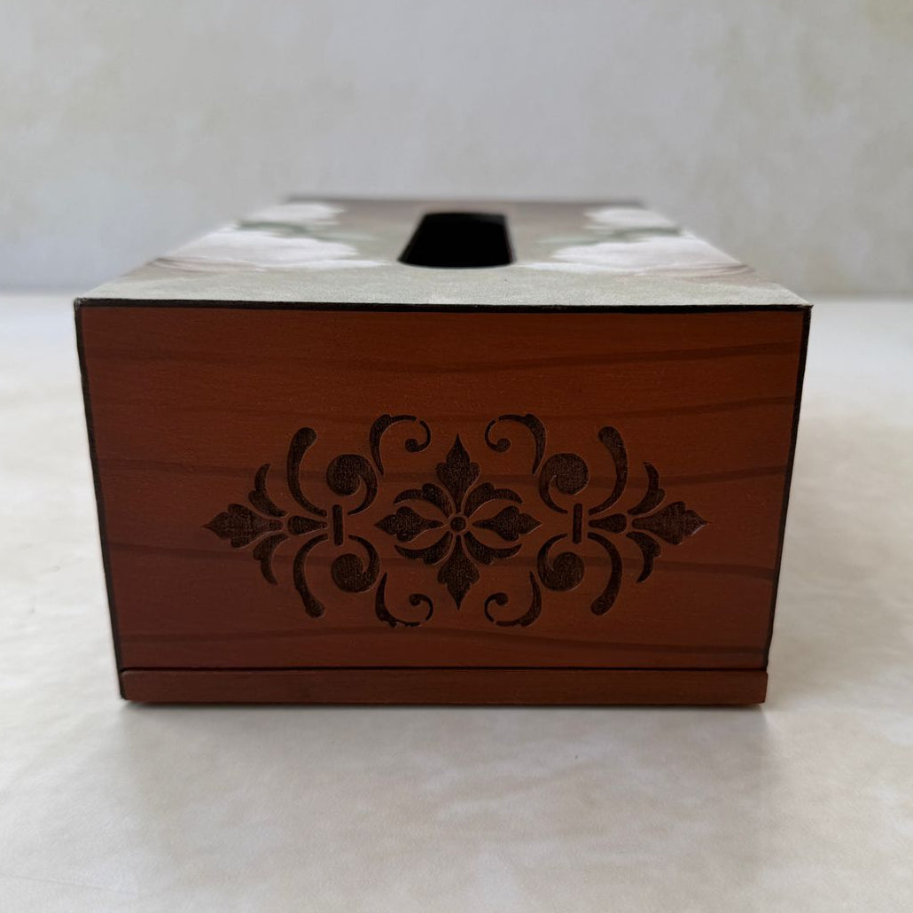 Wooden tissue box with decorative carvings on a white surface
