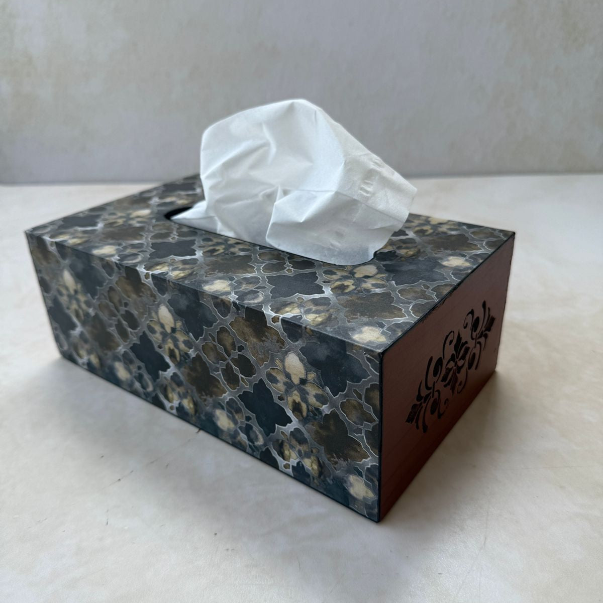 Marble-patterned tissue box with tissues on a white surface
