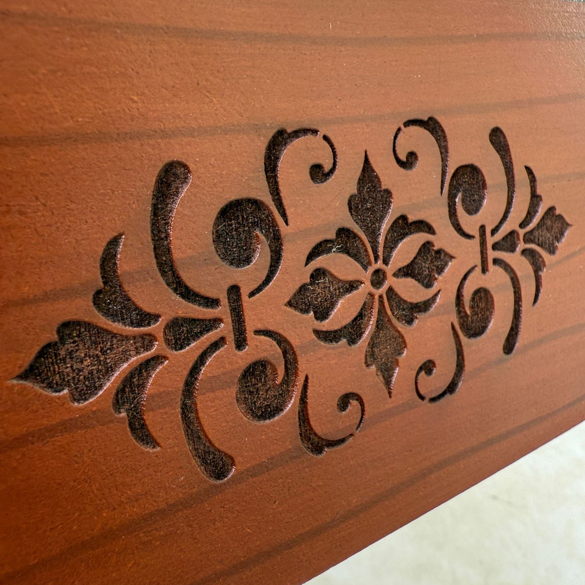 Decorative tissue box with intricate carvings on a plain background